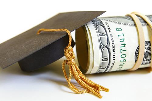 a graduation cap next to money